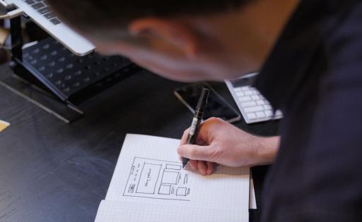 Dan sketching wireframes with marker and paper