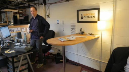 Dan standing by a desk at Electric Citizen's office