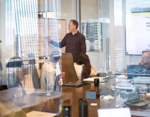 Dan leading a team meeting in a conference room