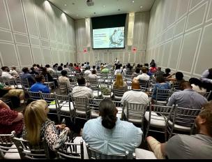 Dan conducting a presentation in large college lecture hall