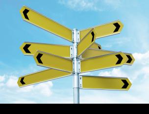 various nondescript yellow directional signs pointing in different directions